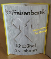 gefaltetes_buch_firmenlogo_raiffeisenbank_kitzbuehel_stjohann